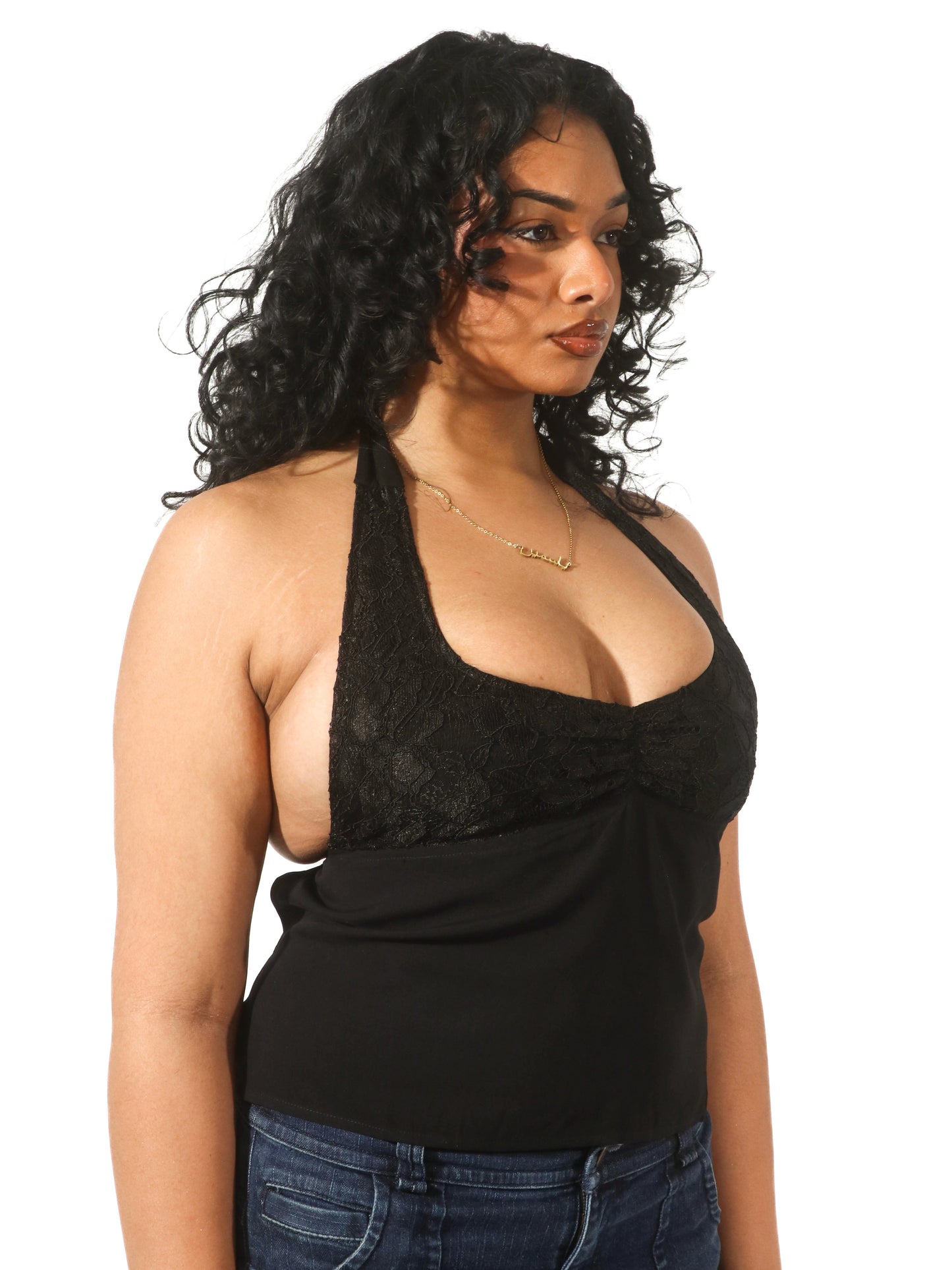 Model wearing a black lace halter top from Yasmin The Label featuring adjustable ties at the top and back; intricate design shown on model who is an Australian size 10-12 and wears M/L.